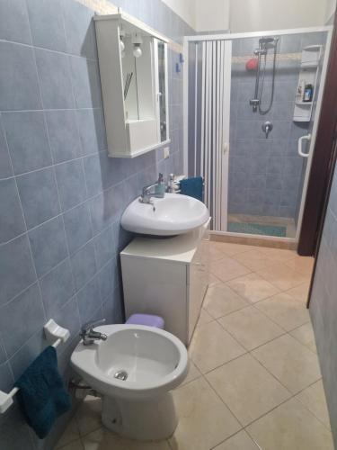 a bathroom with a toilet and a sink and a shower at Casa vacanze MARIA AMATO in Marsala