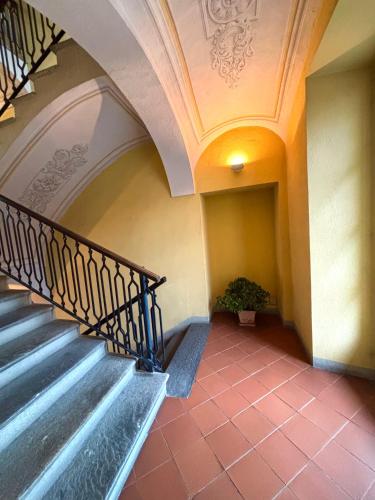 a staircase in a building with a potted plant at ANTICA FILANDA Lattes in Cuneo
