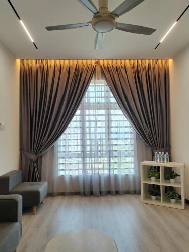 a living room with a ceiling fan and a large window at The Anderson by Triple G Homes in Ipoh