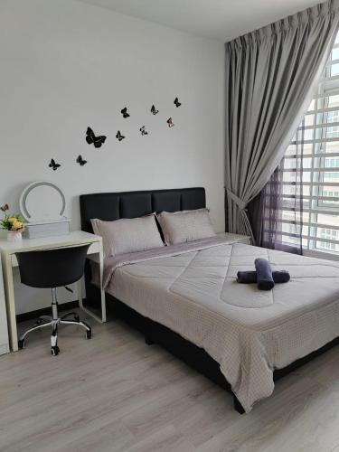 a bedroom with a bed and a desk and a desk at The Anderson by Triple G Homes in Ipoh