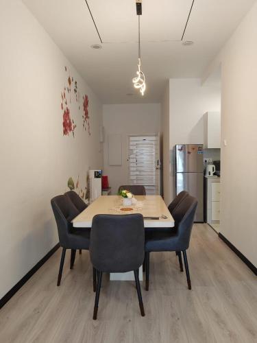 a dining room table and chairs in a kitchen at The Anderson by Triple G Homes in Ipoh