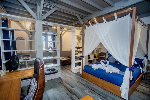 a bedroom with a bed with a canopy at Moonlight Villa Close By Blue Lagoon in Nusa Ceningan