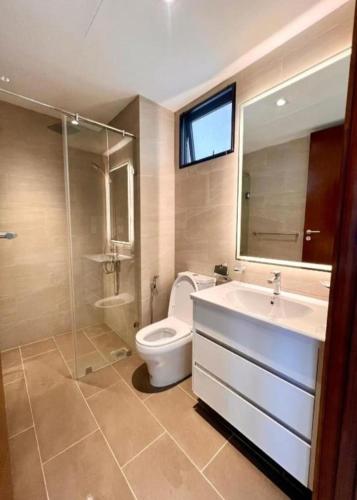 a bathroom with a toilet and a sink and a shower at Trizen Colombo Luxury 3 Bedroom Apartment in Colombo