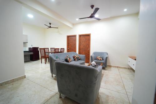 a living room with two couches and a table at Nandan Enclave in Mysore