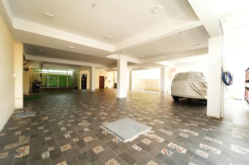 a large empty room with a car parked in it at Nandan Enclave in Mysore