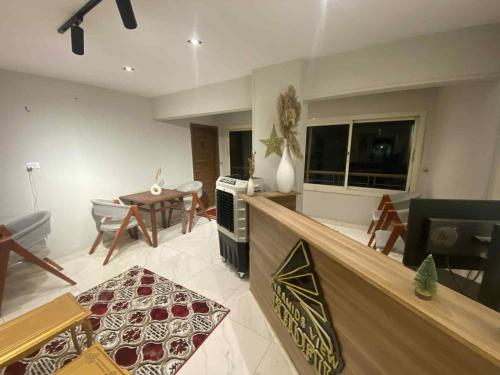 a living room with a kitchen and a dining room at Zlato Pyramids View INN in Cairo