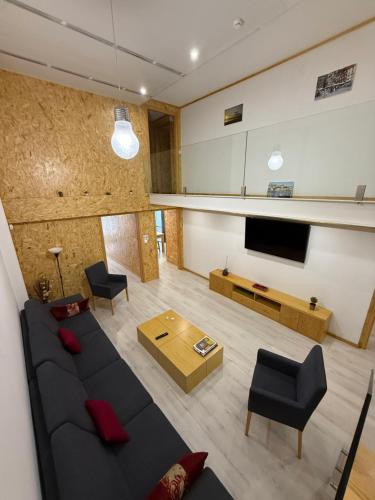 a living room with a couch and a tv at Porto Encanto- 7 Bedrooms in Porto