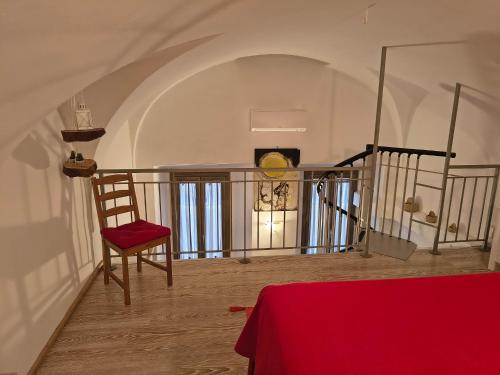 a room with a chair and a staircase with a table at Sesta Strada in Civitavecchia