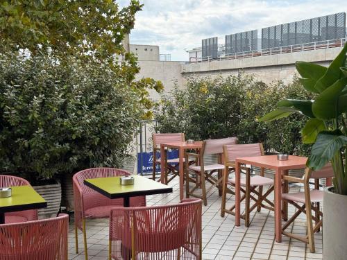 a group of tables and chairs on a patio at Hotel Marisa in Rome