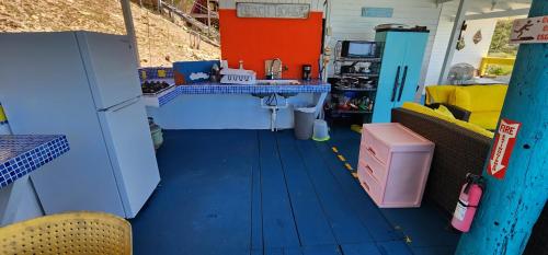 a kitchen with a blue floor and a sink in a room at My Little Shack by the Sea in Lajas