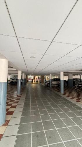 an empty parking lot with cars in a parking garage at Hotel Kalyan Suites in Bengaluru