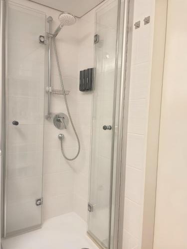 a shower with a glass door in a bathroom at Kerzen Boutique in Bad Salzuflen