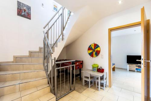a staircase leading up to a living room with a desk at Wohnung mit 3 Schlafzimmern in Solingen