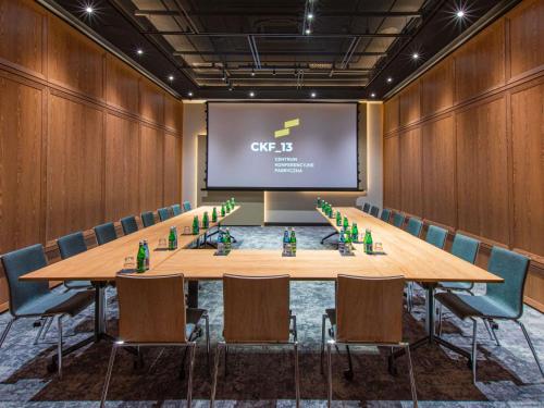 a conference room with a large table and chairs at Mercure Krakow Fabryczna City in Kraków