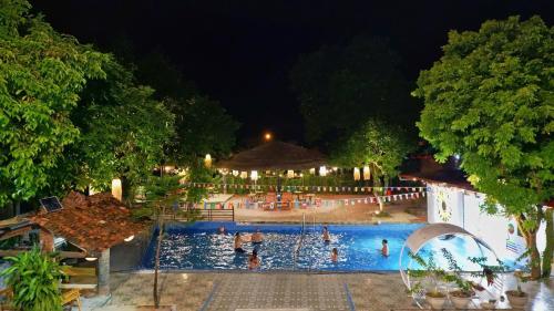a swimming pool at night with people in it at Sunflower House - Ha Giang Loop Tour in Bản Kin