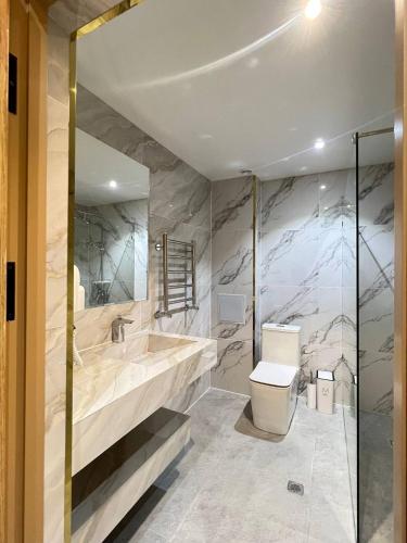 a bathroom with a tub and a toilet and a sink at Rich Land Hotel in Samarkand