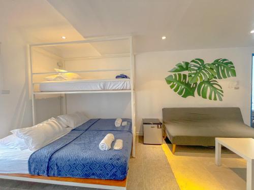a bedroom with a bunk bed and a desk at The Blue Doors- Siargao in General Luna