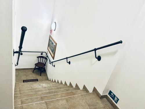 a stairway with a railing on the wall at Penzion Chalupa U Městské brány in Vyškov