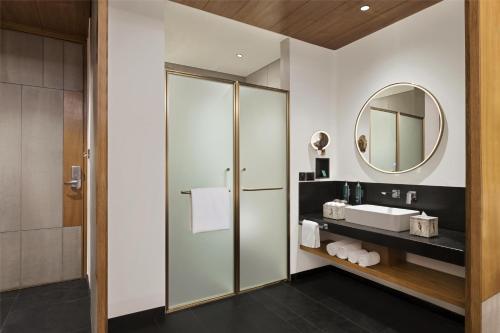 a bathroom with a sink and a mirror at Hilton Hyderabad Genome Valley Resort & Spa in Hyderabad