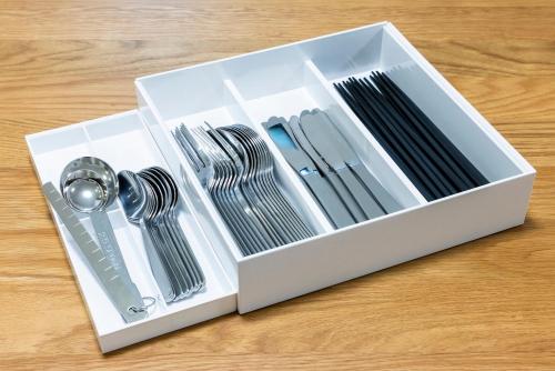 a white box filled with utensils on a table at Amp Flat ブラン呉服 in Fukuoka