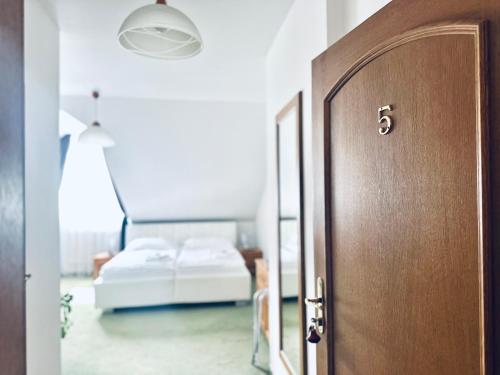 a door leading to a bedroom with a bed at Penzion Chalupa U Městské brány in Vyškov