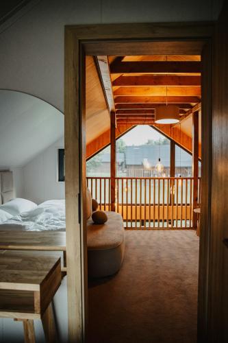 a bedroom with a bed and a balcony at Leśna Polana Górajek in Chycza