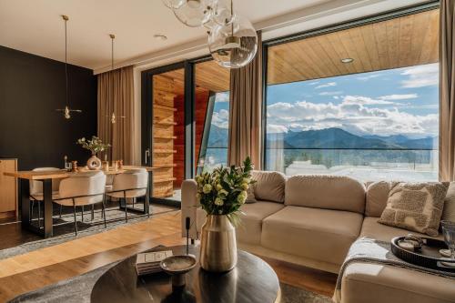 a living room with a couch and a table at Landscape Villas - LoftAffair Spa Collection in Kościelisko