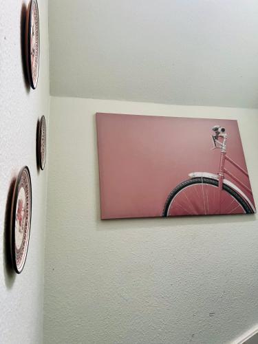 a picture of a bike on a wall with clocks at Seven Palms Villa in Rødby