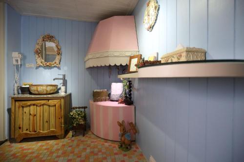 a bathroom with a pink sink and a counter at White Rabbit in Hualien City