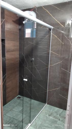 a shower with a glass door in a room at Espaço familiar 3 in Vila Velha
