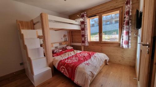 a bedroom with a bunk bed and a window at ASAI707-C03 Appartement 3 pièces - Les Saisies - 7 personnes in Les Saisies