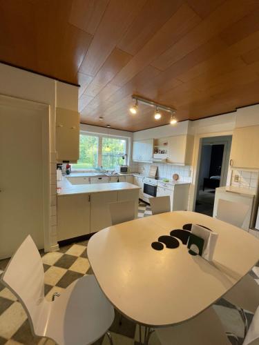 a kitchen with a white table and chairs at Seven Palms Villa in Rødby