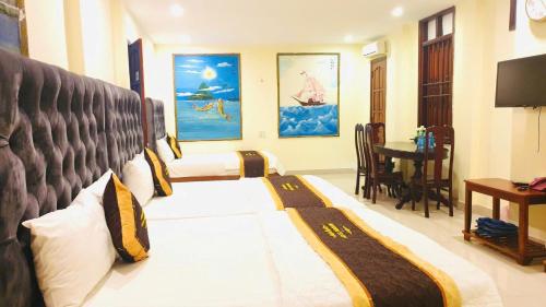 a bedroom with a bed and a table in a room at Window 2 Hotel in Kon Tum