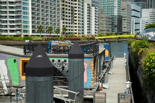 a view of a river in a city with tall buildings at PETALS TOKYO - Floating Hotel in Tokyo
