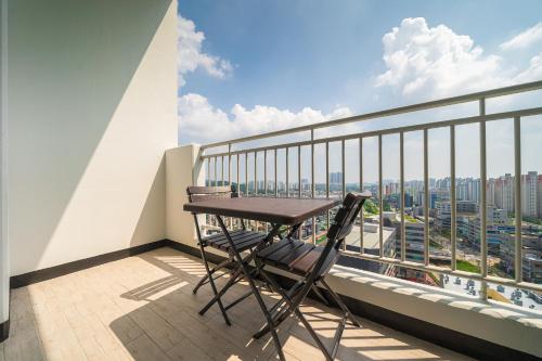 a balcony with a table and a view of a city at Park View Terrace in Paju