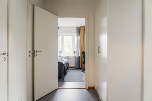 a hallway with a door leading to a bedroom at Guestly Homes - Homely 1BR Apartment in Luleå