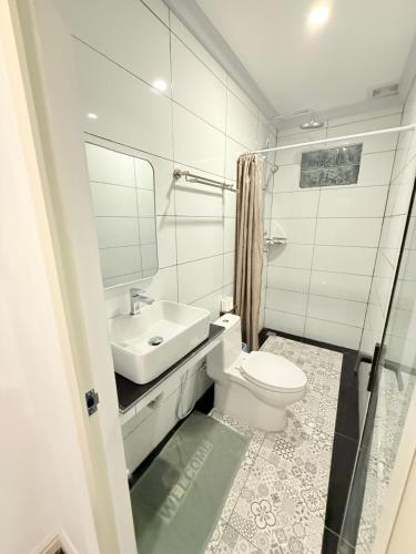 a bathroom with a toilet and a sink at DownTown Hotel in Luang Prabang