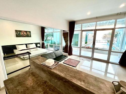 a large living room with a large window at Baancivilize Resort in Khanom