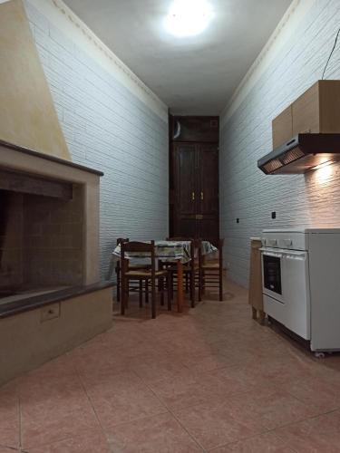 a kitchen with a table and a stove top oven at Meraviglie Salentine - Lecce in Lequile