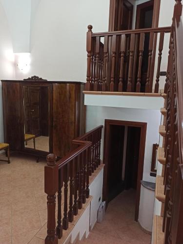 a living room with a staircase and a mirror at Meraviglie Salentine - Lecce in Lequile