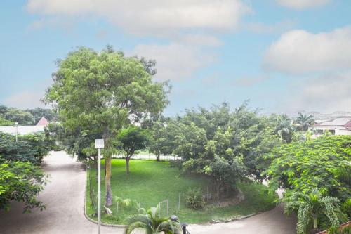 a view of a park with trees and a driveway at ROYALE CROWN VILLA in Abuja