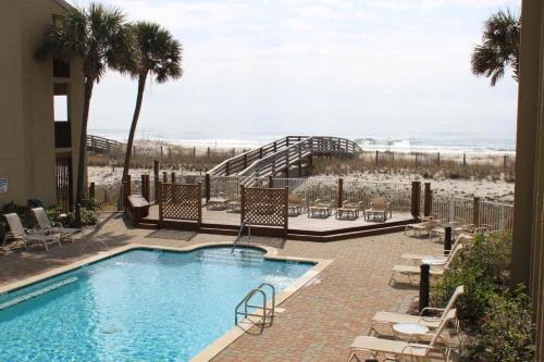 a swimming pool with a view of the beach at Shipwatch B101 in Perdido Key