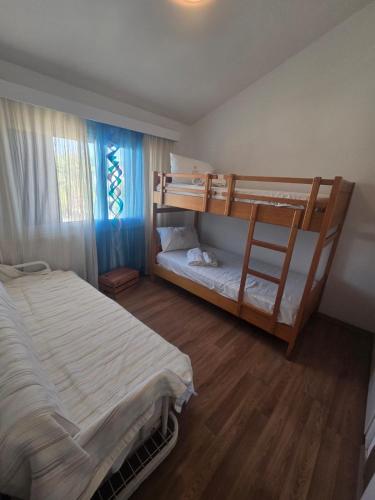 a bedroom with two bunk beds and a window at Lazuli Seafront Beach House Nr18 in Larnaca