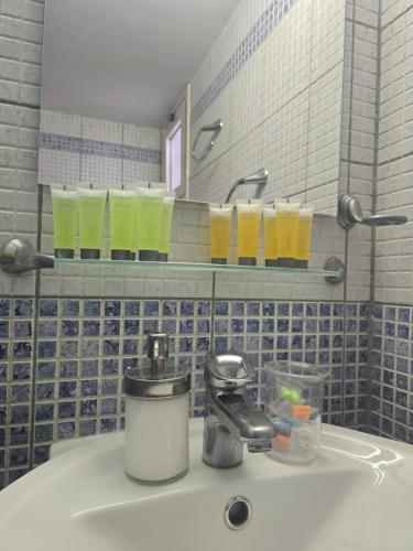 a bathroom with a sink with glasses on a mirror at Lazuli Seafront Beach House Nr18 in Larnaca