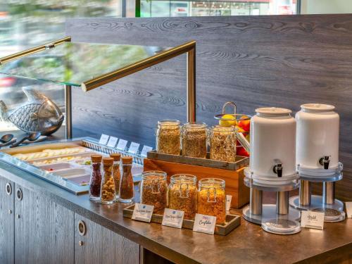 a display of jars of honey on a counter at ibis Styles Hamburg Barmbek in Hamburg