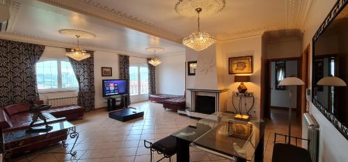 a living room with a table and a fireplace at Villas de Nazare in Maceira