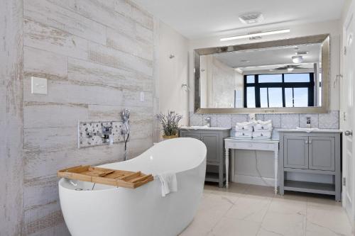 a white bathroom with a tub and a sink at The Oasis at Orange Beach 2411 (Phoenix West II) in Orange Beach