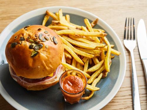 a plate of food with a sandwich and french fries at Ibis Styles Montpellier Aéroport Parc Des Expos in Mauguio