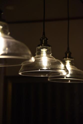 three glass lights are hanging from a ceiling at 内竈ひなた庵 in Kamegawa