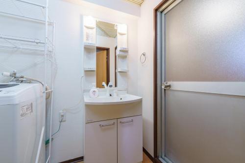 a small bathroom with a sink and a mirror at Nagoya 12min Legoland 25min 3BR 4Beds Sofa 9ppl in Nagoya